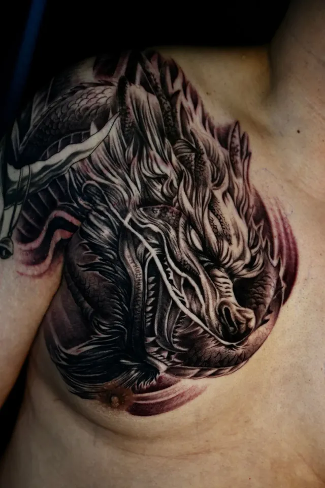 Dragon creature shoulder tattoo