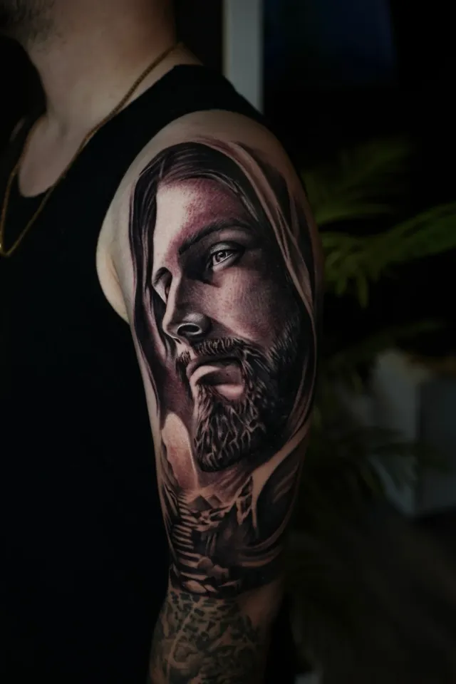 Hooded Jesus portrait tattoo