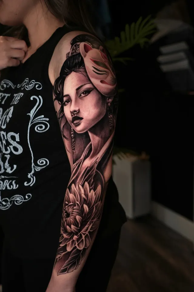 Woman and floral upper arm tattoo