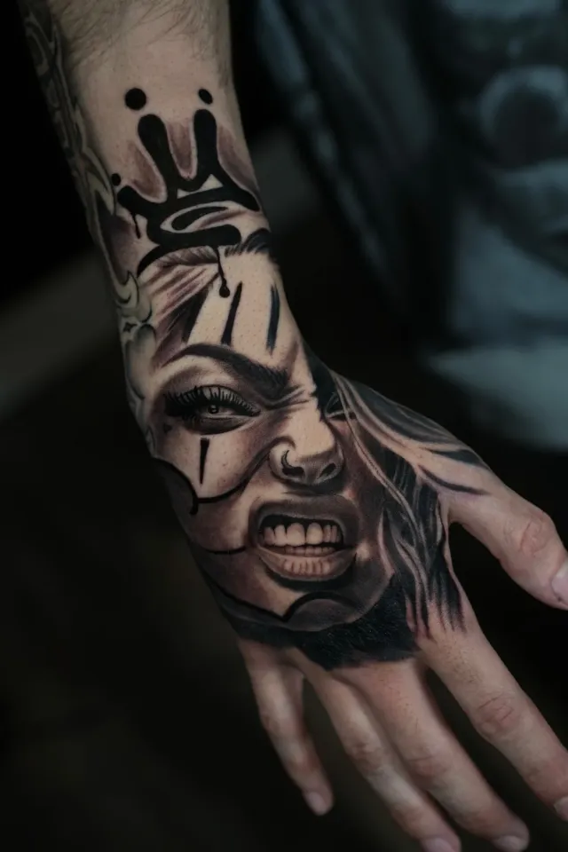 Clown portrait hand tattoo