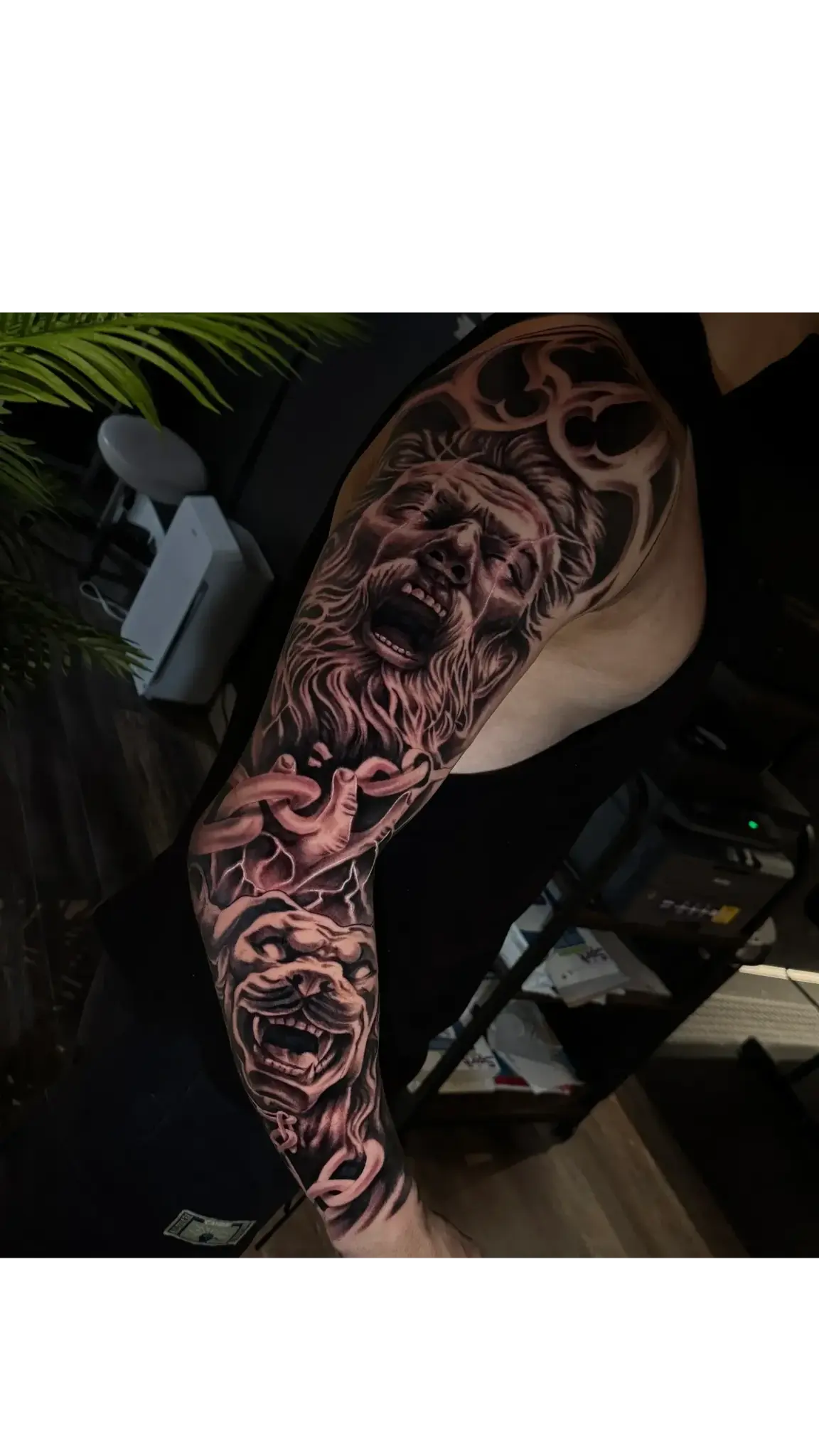Black and grey Zeus and lion sleeve tattoo created at Tattoo Nerds