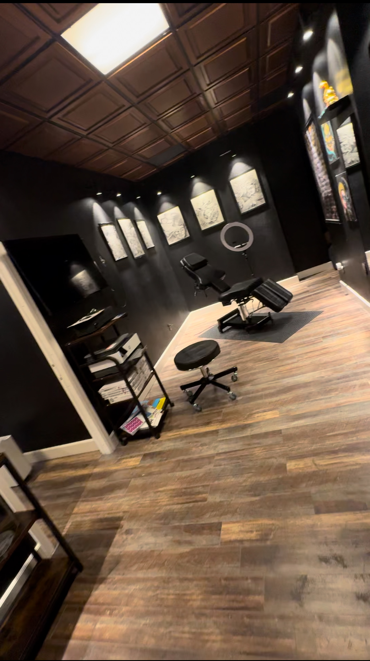 Private tattoo station with professional chair, lighting, and gallery artwork